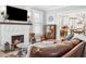 Comfortable living room featuring a brick fireplace and open access to the modern kitchen at 906 E Patterson St, Tampa, FL 33604