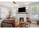 Cozy living room with a painted brick fireplace, hardwood floors and neutral walls at 906 E Patterson St, Tampa, FL 33604