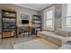 Functional home office with desk, shelving, and a comfortable seating area at 906 E Patterson St, Tampa, FL 33604
