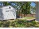 Backyard shed with double doors and a seating area provides a functional and aesthetically pleasing outdoor space at 906 E Patterson St, Tampa, FL 33604