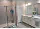 Bright bathroom with a double vanity, white cabinets, and a glass-enclosed shower at 9943 Campanula Ct, Land O Lakes, FL 34637
