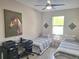 Shared bedroom featuring two twin beds, a desk, and a window with natural light at 9943 Campanula Ct, Land O Lakes, FL 34637