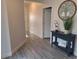 Inviting foyer features stylish flooring, console table with decor, and views into the home at 9943 Campanula Ct, Land O Lakes, FL 34637