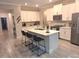 Modern kitchen featuring island with seating, stainless appliances, and white cabinetry at 9943 Campanula Ct, Land O Lakes, FL 34637