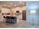Modern kitchen with white cabinetry, center island, stainless steel appliances, and counter seating at 9943 Campanula Ct, Land O Lakes, FL 34637