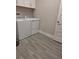 Functional laundry room with a washer, dryer, and upper cabinets for storage at 9943 Campanula Ct, Land O Lakes, FL 34637