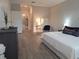 Comfortable bedroom featuring a large bed with white linens, modern decor, and an ensuite bathroom at 9943 Campanula Ct, Land O Lakes, FL 34637