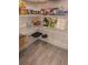 Well-organized pantry featuring adjustable shelving and a variety of food items on a modern tile floor at 9943 Campanula Ct, Land O Lakes, FL 34637