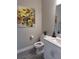 Charming powder room with modern vanity, white countertop, and decorative sunflower art at 9943 Campanula Ct, Land O Lakes, FL 34637