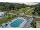 Aerial view of a pool area with multiple lounge chairs and palm trees at 10029 Wellington Ave, Dade City, FL 33525