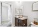 Bathroom featuring a vanity with a sink, mirror, and view into the hallway at 10029 Wellington Ave, Dade City, FL 33525