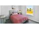 Bedroom featuring a platform bed with neutral walls and natural light from the window at 10029 Wellington Ave, Dade City, FL 33525