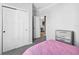 Bedroom showcasing a closet, dresser, and a glimpse into another room at 10029 Wellington Ave, Dade City, FL 33525