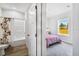 Bedroom with a window view and a doorway to the bathroom at 10029 Wellington Ave, Dade City, FL 33525