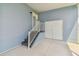 Attached carport featuring stairs leading to a door, and a white double door closet for storage at 10029 Wellington Ave, Dade City, FL 33525