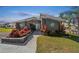 Charming clubhouse entrance surrounded by vibrant landscaping, creating a welcoming atmosphere at 10029 Wellington Ave, Dade City, FL 33525