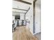 Open-concept home with exposed beams and a view into the dining room and kitchen at 10029 Wellington Ave, Dade City, FL 33525