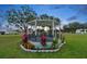 Hexagonal gazebo with flowering plants at the base at 10029 Wellington Ave, Dade City, FL 33525