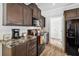 Well-equipped kitchen with modern appliances and dark wood cabinetry offering ample storage at 10029 Wellington Ave, Dade City, FL 33525