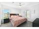 A cozy main bedroom with carpeted floors, natural light, and modern furnishings at 10029 Wellington Ave, Dade City, FL 33525
