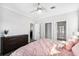 A modern main bedroom with a ceiling fan, carpeted floors, and two closets at 10029 Wellington Ave, Dade City, FL 33525