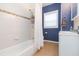 Bright bathroom featuring tiled shower/tub combo with updated fixtures and ample storage space at 1008 E 25Th Ave, Tampa, FL 33605