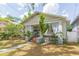 Charming single-story home with a welcoming front porch and lush landscaping at 1008 E 25Th Ave, Tampa, FL 33605