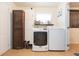 Functional laundry room with modern appliances, storage cabinets, and natural light at 1008 E 25Th Ave, Tampa, FL 33605