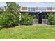 The lawn and a privacy hedge provide an attractive view from the screened-in porch at 10135 Post Harvest Dr, Riverview, FL 33578