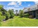 Scenic view of the backyard, featuring well-maintained lawn and vibrant landscaping at 10135 Post Harvest Dr, Riverview, FL 33578