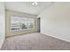Bright bedroom with large window, neutral carpet and ample natural light at 10135 Post Harvest Dr, Riverview, FL 33578