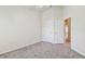Bright bedroom features neutral carpeting, white trim and door frames and two open doorways at 10135 Post Harvest Dr, Riverview, FL 33578
