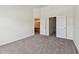 Spacious carpeted bedroom with multiple doorways to a bathroom and closet space at 10135 Post Harvest Dr, Riverview, FL 33578