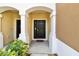 The entrance features a black door, covered entry, and manicured landscaping at 10135 Post Harvest Dr, Riverview, FL 33578