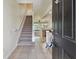 Inviting foyer with staircase and views of the kitchen and living areas at 10135 Post Harvest Dr, Riverview, FL 33578