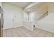 A view of the stairs, kitchen and an entry door can be seen in this interior shot at 10135 Post Harvest Dr, Riverview, FL 33578