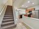 Open floor plan showcasing staircase, kitchen with stainless steel appliances, and living room at 10135 Post Harvest Dr, Riverview, FL 33578