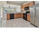 Modern kitchen with stainless appliances, spacious countertops, and an open view to the living area at 10135 Post Harvest Dr, Riverview, FL 33578