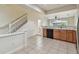 The kitchen features an open concept with a breakfast bar and a view of the staircase at 10135 Post Harvest Dr, Riverview, FL 33578