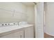 A well-lit laundry room features a white washer and dryer with wire shelving at 10135 Post Harvest Dr, Riverview, FL 33578