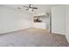 Large living room with kitchen views and doorway to a bathroom with wood accents at 10135 Post Harvest Dr, Riverview, FL 33578