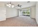 Spacious living room with ceiling fan and sliding glass doors leading to the lanai at 10135 Post Harvest Dr, Riverview, FL 33578
