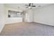 Open-concept living room with views of the kitchen and a hallway leading to a bathroom at 10135 Post Harvest Dr, Riverview, FL 33578