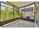 The screened-in patio features concrete floors, black framing, and a view of the community at 10135 Post Harvest Dr, Riverview, FL 33578