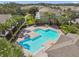 Beautiful community pool with brick surround, lounge chairs, and palm trees at 10135 Post Harvest Dr, Riverview, FL 33578