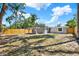 Expansive backyard featuring a well-maintained lawn and sturdy wooden fence, perfect for outdoor activities and privacy at 10218 Lola St, Tampa, FL 33612
