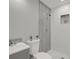 Bathroom featuring walk-in shower with gray backsplash, gray vanity, toilet, and plants at 10218 Lola St, Tampa, FL 33612