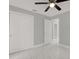 Bedroom featuring a closet with sliding doors, an open door, and ceiling fan at 10218 Lola St, Tampa, FL 33612