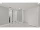 A bedroom with white marble floor tiles, gray walls, white trim, and white closet doors at 10218 Lola St, Tampa, FL 33612