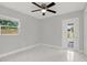 Bedroom featuring a window, a door leading to the outside, and marble floor tiles at 10218 Lola St, Tampa, FL 33612